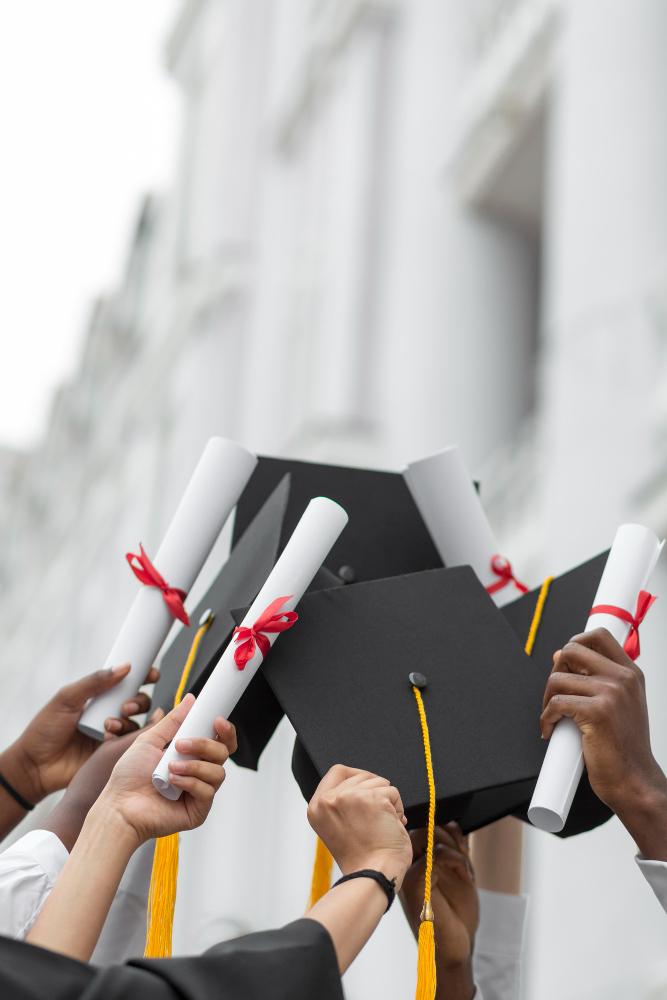 Graduates raising diplomas and graduation caps, representing Edu Span’s guided support to student success